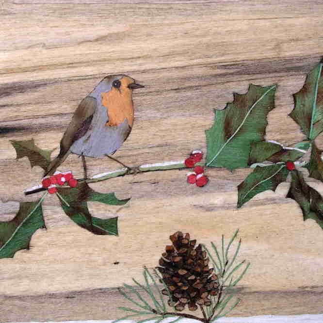 marquetry picture of a robin on a holly twig and a pine cone